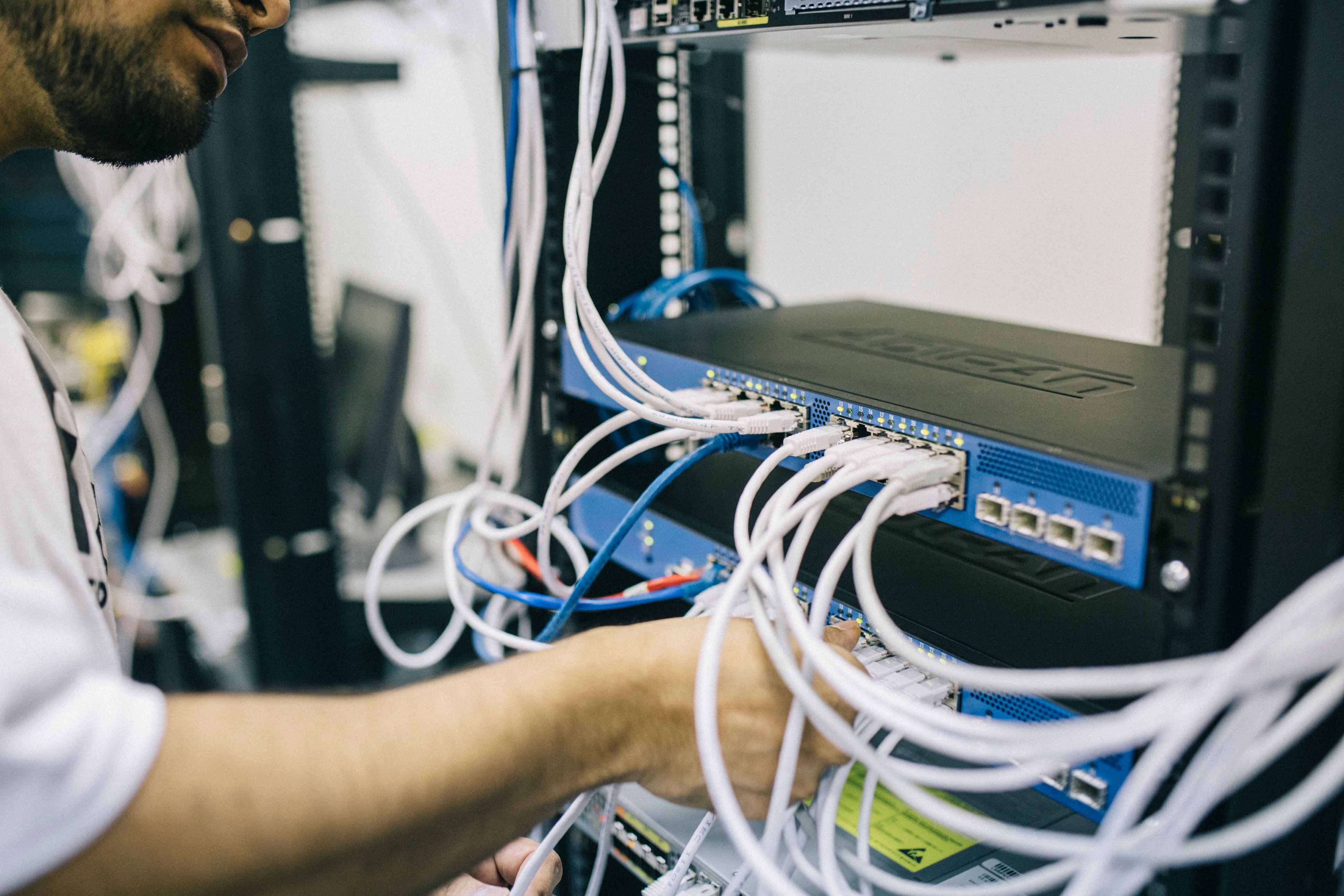 Technicien informatique travaillant avec une baie de serveurs réseau